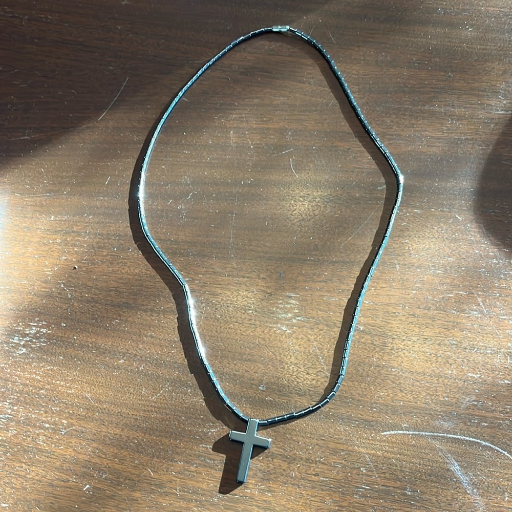 Cross and bead necklace. Color is shiny grayish silver.